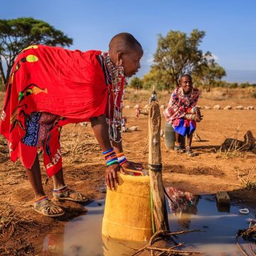I Stock 872089808 African woman from Masai tribe collecting wat